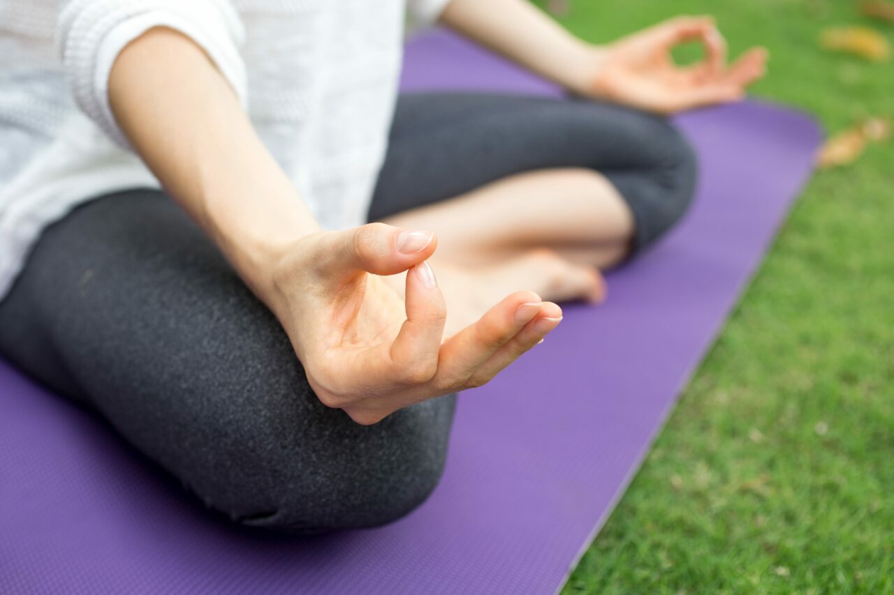 Close up of female hand gesturing zen outdoors