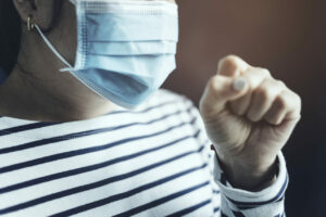 Sick woman wearing a face mask to stop the spread of coronavirus